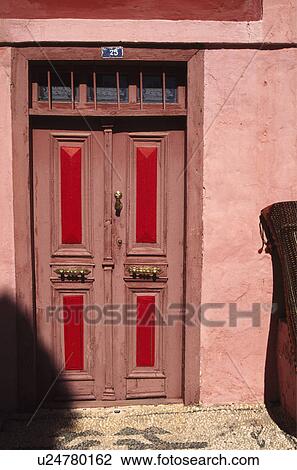 Stock Image - Close-up of red Turkish front door. Fotosearch
