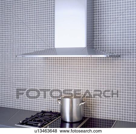 Close-up of stainless steel extractor above tall steel pan on gas and halogen hob View Large Photo Image Stock Photo - Close-up of stainless steel extractor above tall steel pan on gas and halogen hob . Fotosearch