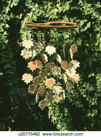 Stock Image - Close up of terracotta leaf shaped wind chime. Fotosearch