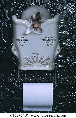 Stock Image - Close-up of Victorian porcelain towel holder above toilet roll. Fotosearch