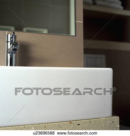 Close up of white ceramic basin with stainless steel tap View Large Photo Image Stock Photo - Close up of white ceramic basin with stainless steel tap. Fotosearch