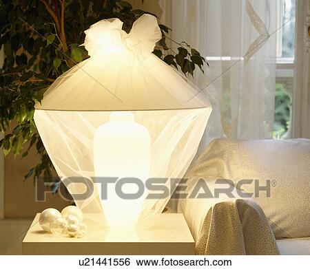 Stock Photograph - Close-up of white lamp covered with white muslin. Fotosearch