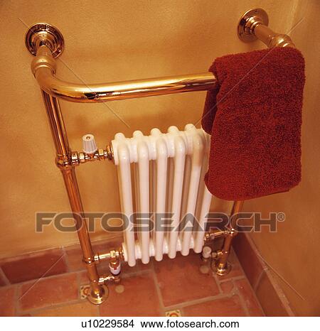 Close-up of white radiator with integral brass towel rail and red towel View Large Photo Image Picture - Close-up of white radiator with integral brass towel rail and red towel. Fotosearch