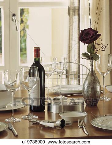 Close up of wineglasses with wine bottle and cutlery on table with red rose in metallic vase View Large Photo Image Stock Image - Close up of wineglasses with wine bottle and cutlery on table with red rose in metallic vase. Fotosearch