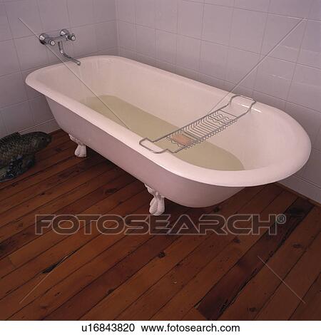 Close-up of wooden flooring and white rolltop bath half-full of water View Large Photo Image Stock Image - Close-up of wooden flooring and white rolltop bath half-full of water. Fotosearch
