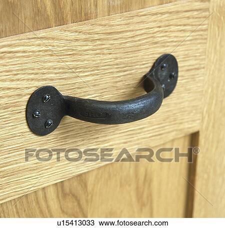 Close-up of wrought-iron handle on wooden cupboard door View Large Photo Image Stock Image - Close-up of wrought-iron handle on wooden cupboard door. Fotosearch