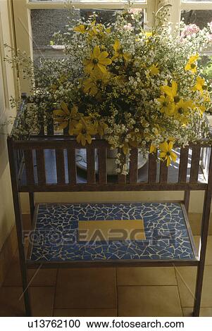 Close-up of yellow flower arrangement on mosaic table View Large Photo Image Stock Image - Close-up of yellow flower arrangement on mosaic table. Fotosearch
