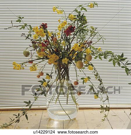 Picture - Close-up of yellow flowers in glass vase. Fotosearch
