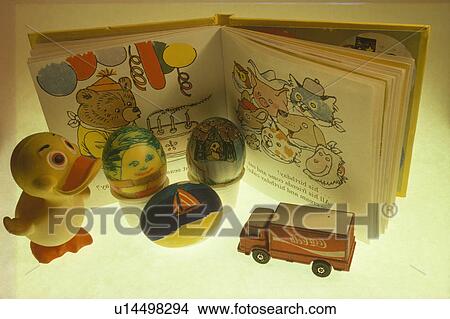 Close Up Toys And Book With Blown Eggs Decorated And Painted In