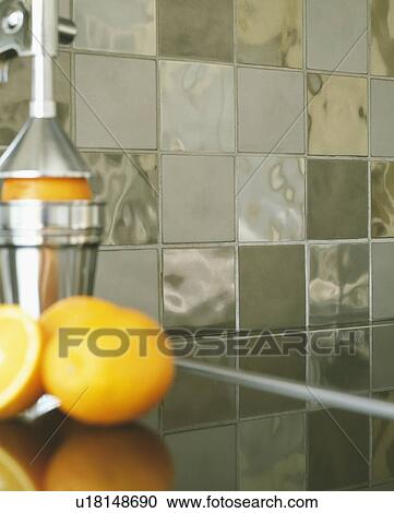 Stock Image - Closeup of metal tiles behind kitchen counter.. Fotosearch