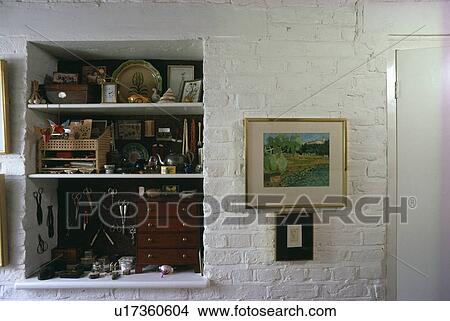 Collection of antique boxes and ceramics on alcove shelves beside picture on white painted brick wall View Large Photo Image Picture - Collection of antique boxes and ceramics on alcove shelves beside picture on white painted brick wall. Fotosearch