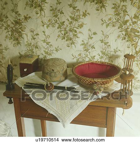 Collection of antique objects on small pine table below floral wallpaper View Large Photo Image Picture - Collection of antique objects on small pine table below floral wallpaper. Fotosearch