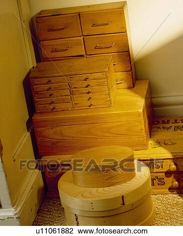 Stock Image - Collection of circular and square wooden boxes with miniature chests of drawers. Fotosearch