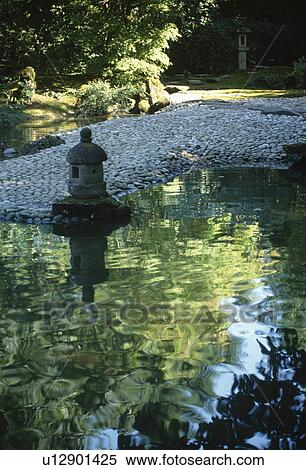 Concrete Japanese lantern beside stream in oriental style Japanese courtyard with trees reflected in stream View Large Photo Image Stock Photography - Concrete Japanese lantern beside stream in oriental style Japanese courtyard with trees reflected in stream. Fotosearch