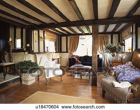 Cottage Livingroom With Black Beams And Light Wood Laminate