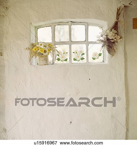 Stock Photo - Cottage window with daisies on windowsill. Fotosearch