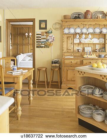 Country kitchen with pine dresser and table and polished wood floor View Large Photo Image Stock Image - Country kitchen with pine dresser and table and polished wood floor. Fotosearch