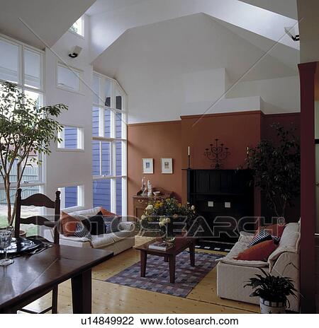 Cream sofas in modern living room with terracotta wall View Large Photo Image Stock Image - Cream sofas in modern living room with terracotta wall. Fotosearch