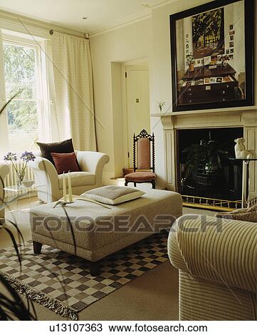 Cream upholstered stool in traditional cream living room View Large Photo Image Stock Image - Cream upholstered stool in traditional cream living room. Fotosearch
