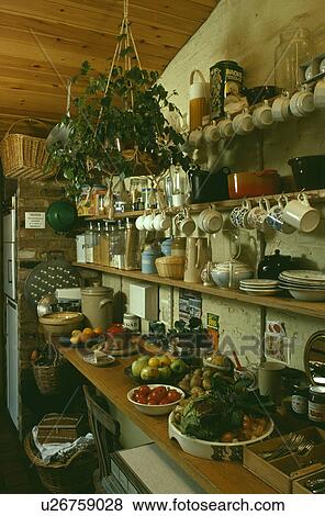 Crockery and food on shelves in small kitchen larder View Large Photo Image Stock Photo - Crockery and food on shelves in small kitchen larder. Fotosearch