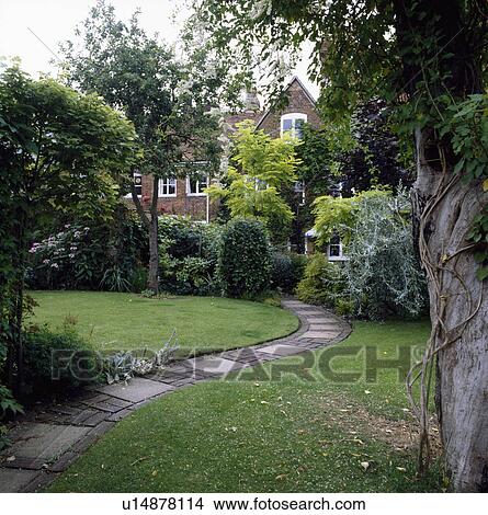 Curved paved path across lawn in large town garden View Large Photo Image Picture - Curved paved path across lawn in large town garden. Fotosearch