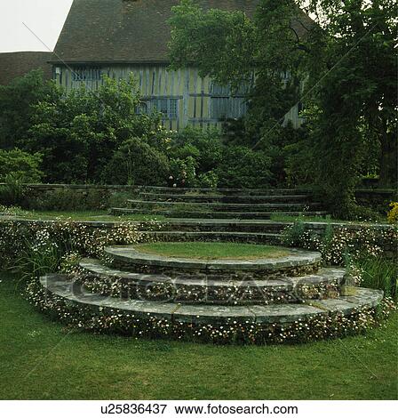 Curved stone steps in large country garden in front of Tudor house View Large Photo Image Stock Photo - Curved stone steps in large country garden in front of Tudor house. Fotosearch