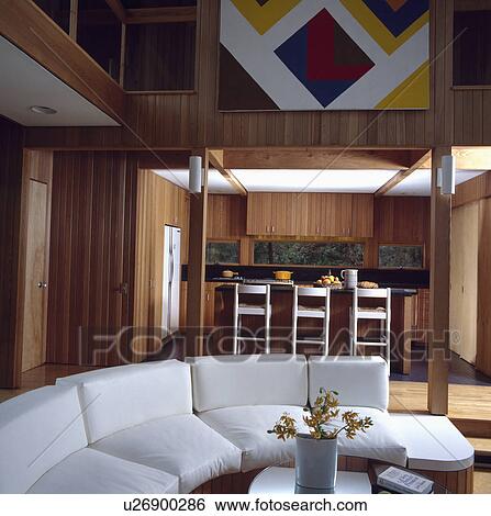 Curved white sofa in modern panelled living room View Large Photo Image Stock Photograph - Curved white sofa in modern panelled living room. Fotosearch