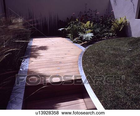 Stock Photo - Decking in small walled town garden. Fotosearch