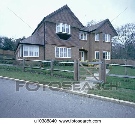 Detached newbuild house with wooden bar fence and gate View Large Photo Image Stock Image - Detached newbuild house with wooden bar fence and gate. Fotosearch
