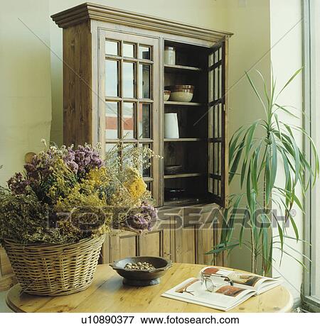 Dried Flowers On Pine Table In Dining Room With Dresser With Glass