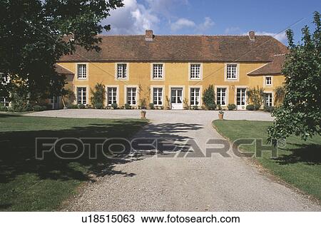 Stock Image - Drive leading to large country house. Fotosearch