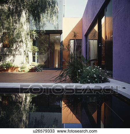 Exterior of architectural home with central terrace and pool View Large Photo Image Stock Image - Exterior of architectural home with central terrace and pool. Fotosearch