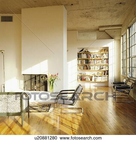 Stock Image - Fireplace in modern living room with wooden flooring. Fotosearch