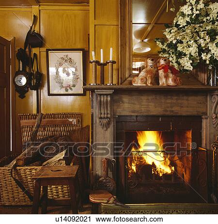 Stock Image - Fireplace in traditional country living room. Fotosearch