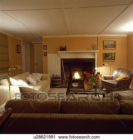 Stock Image - Fireplace in traditional country living room. Fotosearch