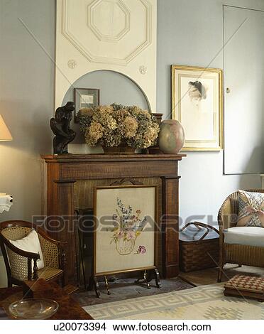 Firescreen in front of fireplace in traditional living room View Large Photo Image Picture - Firescreen in front of fireplace in traditional living room. Fotosearch