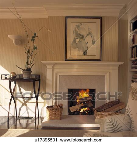 Stock Image - Floral picture above fireplace in contemporary living room. Fotosearch