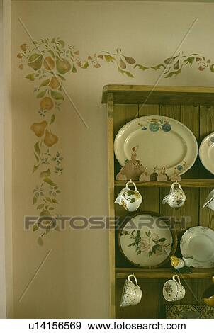 Floral stencil on wall above dresser with floral patterned plates View Large Photo Image Stock Photo - Floral stencil on wall above dresser with floral patterned plates. Fotosearch