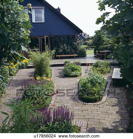Flower beds in paving in front of modern house in summer View Large Photo Image Picture - Flower beds in paving in front of modern house in summer . Fotosearch