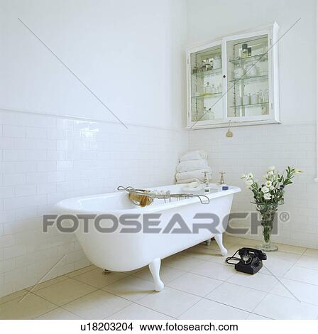 Free standing claw foot bath in all white bathroom View Large Photo Image Picture - Free standing claw foot bath in all white bathroom. Fotosearch