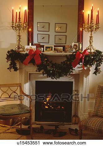 Fresh Holly And Ivy Christmas Garland On Mantelpiece With Lighted