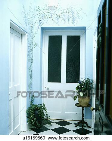 Front door open on to hall with painted mural of wisteria on the walls above white half-glazed door View Large Photo Image Stock Photo - Front door open on to hall with painted mural of wisteria on the walls above white half-glazed door . Fotosearch