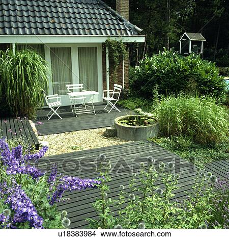 Furniture on patio in country garden in summer View Large Photo Image Picture - Furniture on patio in country garden in summer. Fotosearch
