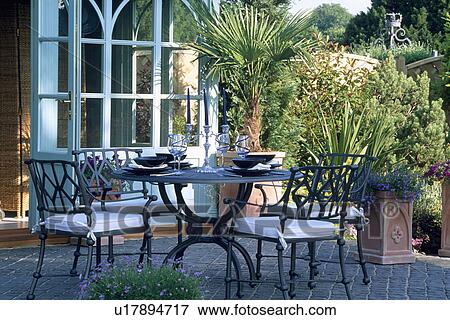 Furniture on patio in country garden in summer View Large Photo Image Stock Photo - Furniture on patio in country garden in summer. Fotosearch