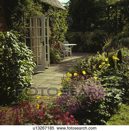 Furniture on patio in country garden in summer View Large Photo Image Stock Photography - Furniture on patio in country garden in summer. Fotosearch