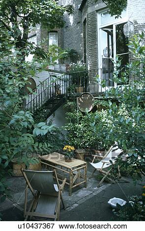 Furniture on patio in town garden in summer View Large Photo Image Stock Photo - Furniture on patio in town garden in summer. Fotosearch