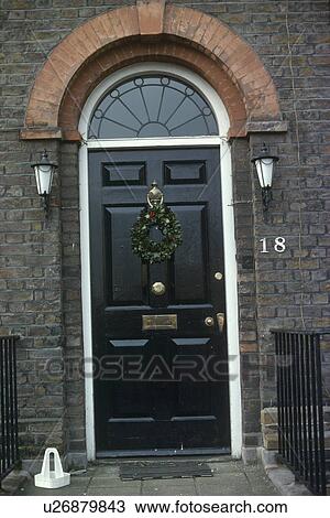 GEorgian black front door with Christmas wreath below fanlight View Large Photo Image Stock Image - GEorgian black front door with Christmas wreath below fanlight. Fotosearch