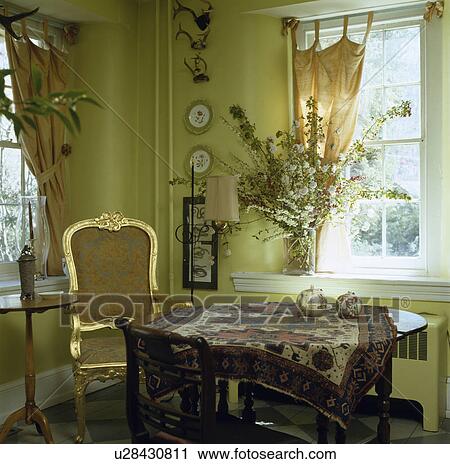 Gilt framed 18th century chair in pale green dining room with oriental rug on circular table View Large Photo Image Stock Image - Gilt framed 18th century chair in pale green dining room with oriental rug on circular table. Fotosearch