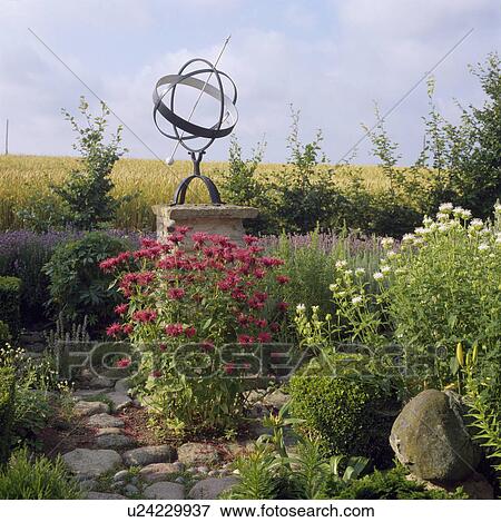 Stock Photo - Gimbal on stone plinth in country garden. Fotosearch