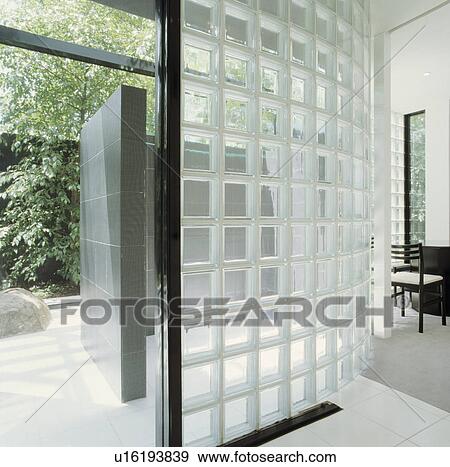 Glass brick wall seperating modern bathroom and hall with open door and view of garden View Large Photo Image Stock Photo - Glass brick wall seperating modern bathroom and hall with open door and view of garden. Fotosearch